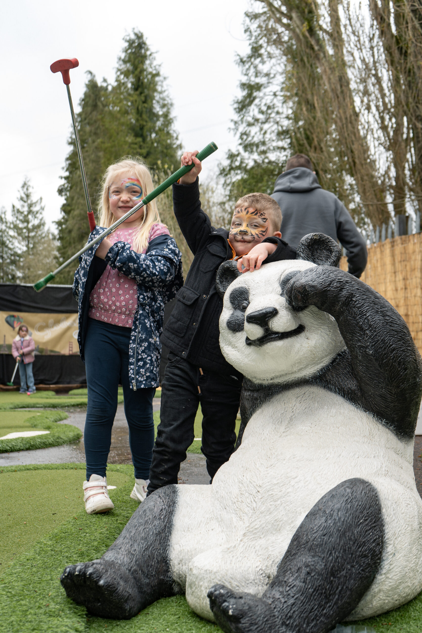 A young boy and girl standing next to a fibreglass model of a panda. Part of the Globetrotters Prop Hire range