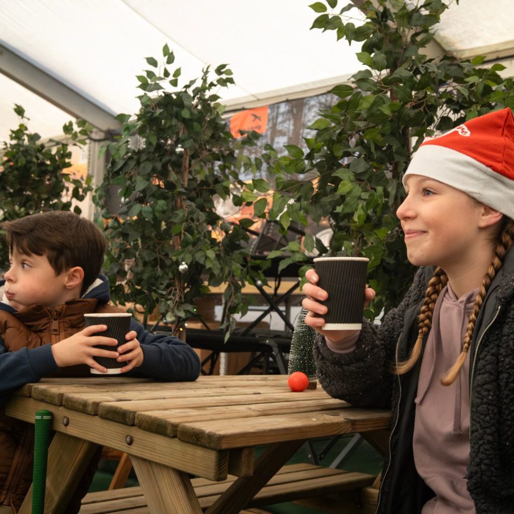 Girl sitting down drinking hot chocolate