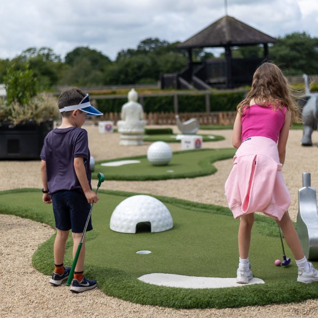 A young boy and girl playing crazy golf