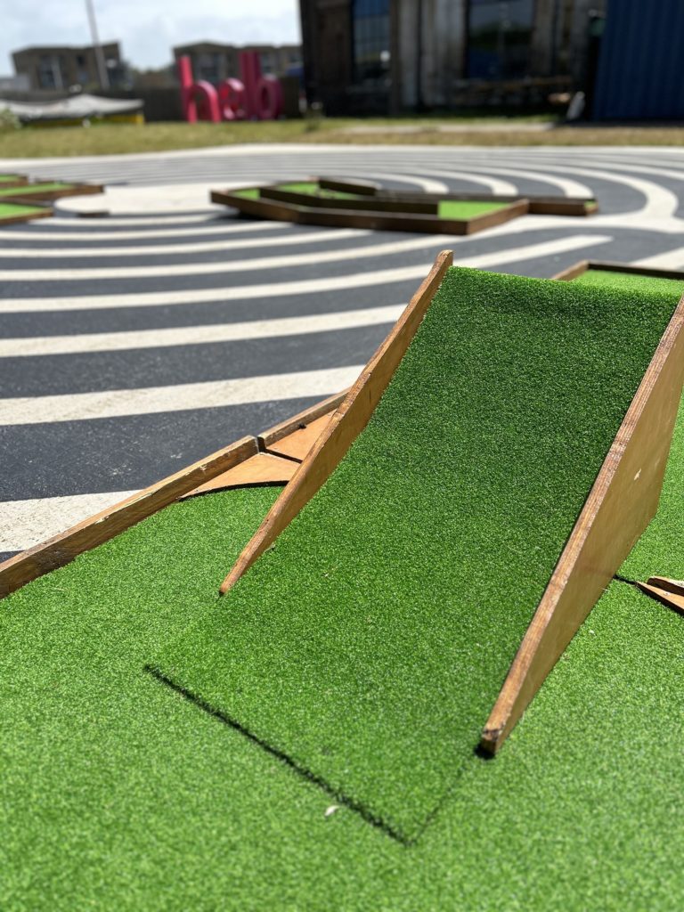 Mini golf ramp obstacle made out of wood and astroturf