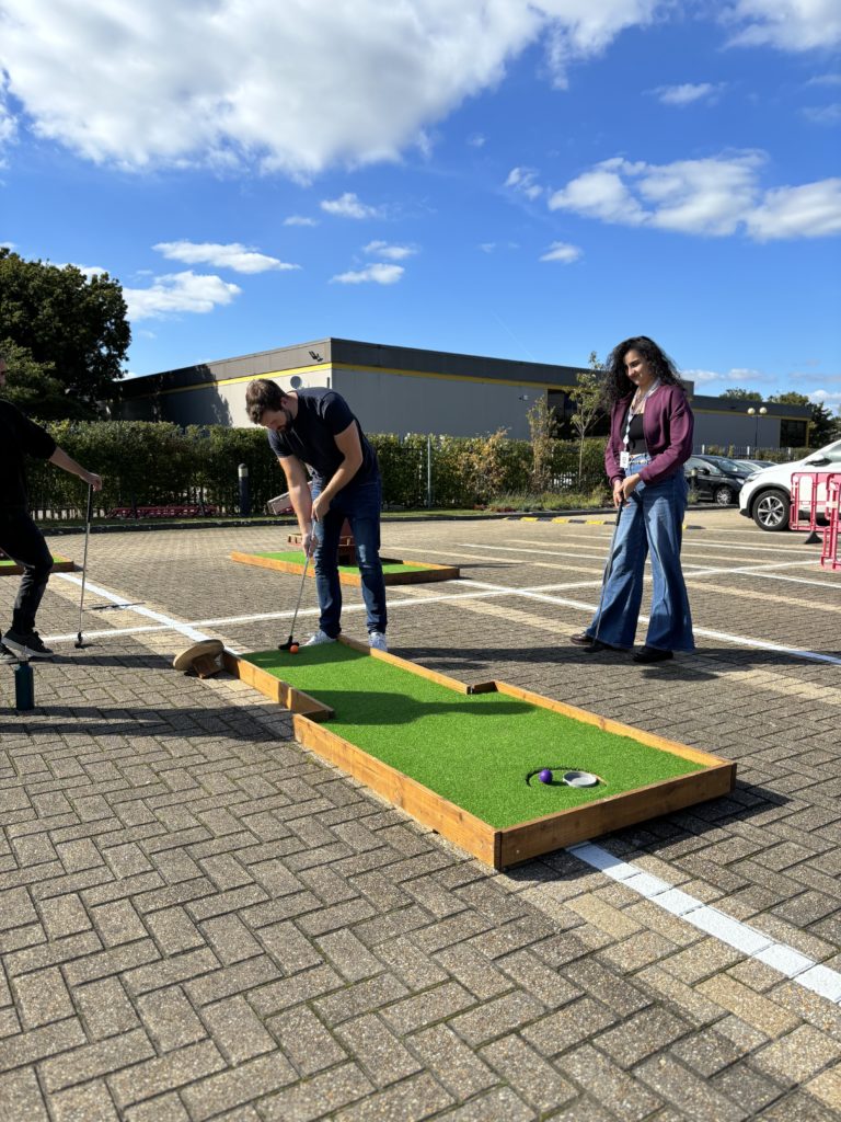 Man lining up crazy golf putt