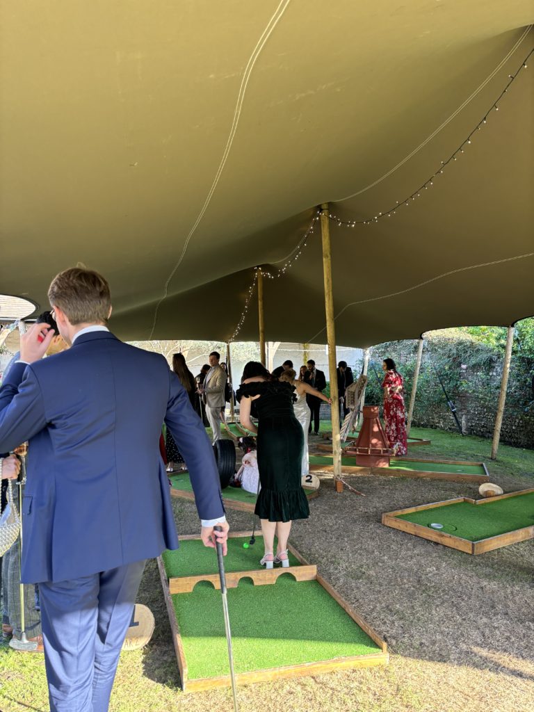 Mobile mini golf course under stretch tent