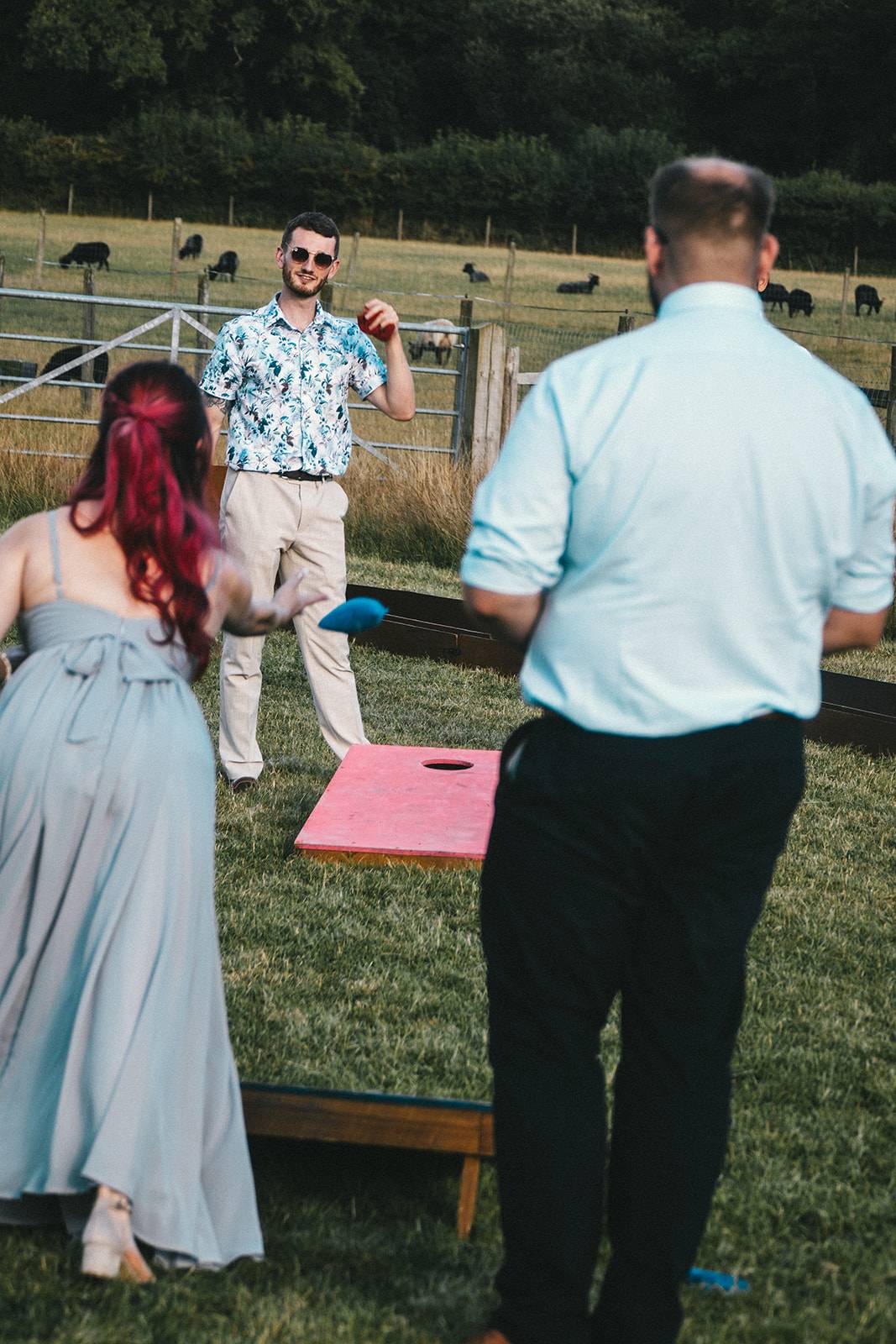man and woman playing a game of cornhole